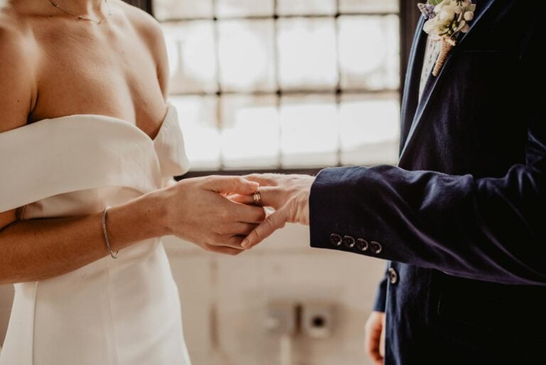 Bride and groom exchanging rings during wedding ceremony in Fontainebleau.