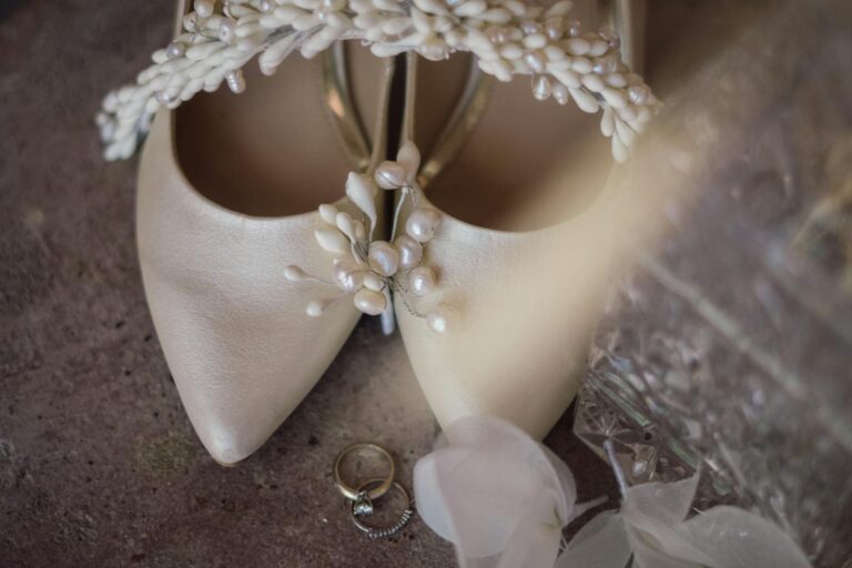 Elegant wedding shoes with pearl details and rings for a romantic wedding day.